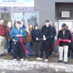 Dustin Miller cuts the ribbon held by Ben Marolt & Edward Addy at the Grand Opening Ceremony of Cold Snap Technology's Eveleth Office location.